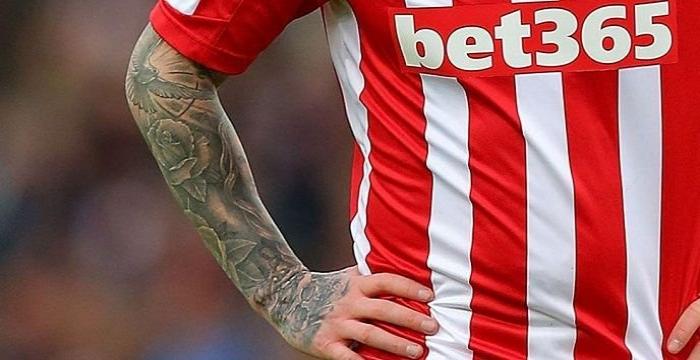 Can you identify the footballer from their tattoo?